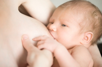 Portrait of baby breastfeeding